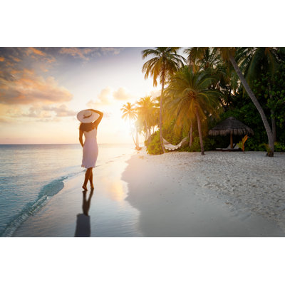 A Travel Concept with a Woman Standing on a Paradise Beach and Enjoying the Sunset 1 Piece Wrapped Canvas Wall Art