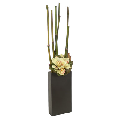 Bambou avec des orchidées cymbidium dans un grand pot en métal