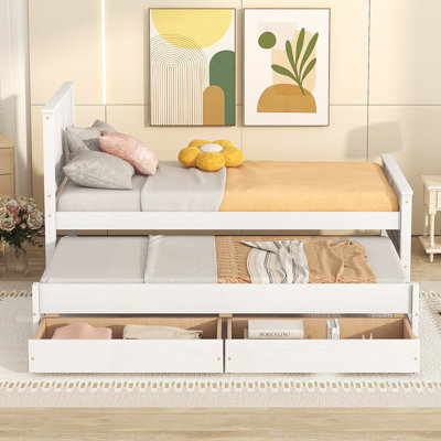 Élégant lit plateforme avec lit gigogne et tiroirs, parfait pour un espace de couchage et de rangement supplémentaire dans les maisons modernes.