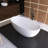 61" Matte White Freestanding Bathtub Deep Soak Oval Design, Solid Surface & Built-In Chrome Drain