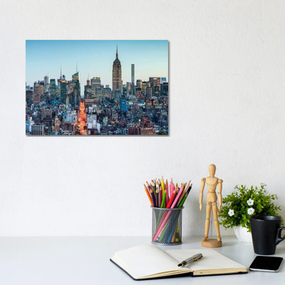 Manhattan Skyline With Empire State Building At Dusk by Jan Becke - Wrapped Canvas Print
