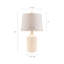 Une lampe de table en céramique Contour, un abat-jour blanc filtre doucement la lumière dans votre pièce et complète la base.