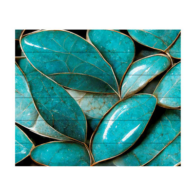 Feuilles turquoise sur bois