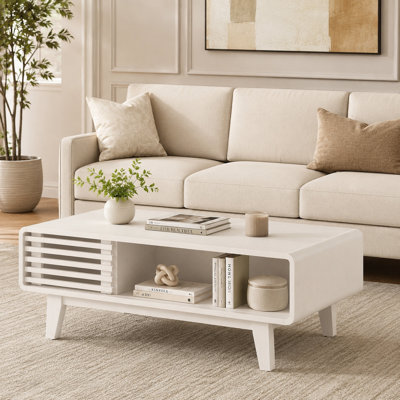White medieval farmhouse rectangular storage coffee table with four storage compartments and solid wood legs.