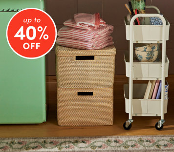 Bins & baskets up to 40% off featuring woven rattan storage boxes with folded towels and white rolling cart