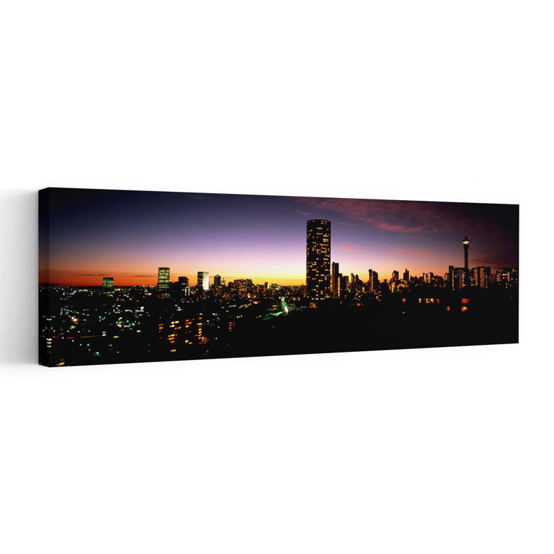 Buildings In A City Lit Up At Night Johannesburg South Africa by Mark Segal - Wrapped Canvas Panoramic Print