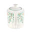 Théière en porcelaine et feuilles vertes