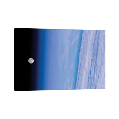 A Full Moon Above Earth's Horizon And Airglow by Stocktrek Images - Wrapped Canvas Print