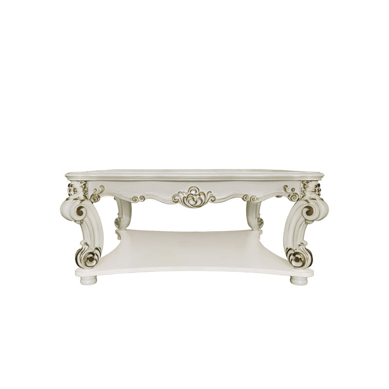 Table basse Vendome avec pieds à volutes et garniture décorative, parfaite pour les espaces de vie élégants