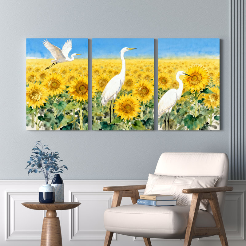 Ensemble de 3 tableaux sur toile représentant un champ de tournesols avec des hérons blancs, H 18 po x l 36 po