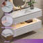 Meuble-lavabo suspendu de 122 cm (L) x 53 cm (P) avec comptoir en pierre, éclairage DEL intégré, design cannelé à deux niveaux, tiroirs à fermeture amortie, blanc