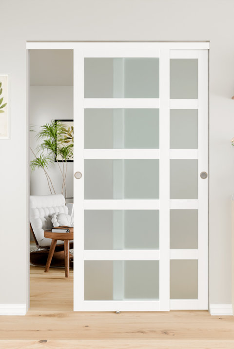 White sliding pocket doors with frosted glass panels installed in a modern interior doorway.