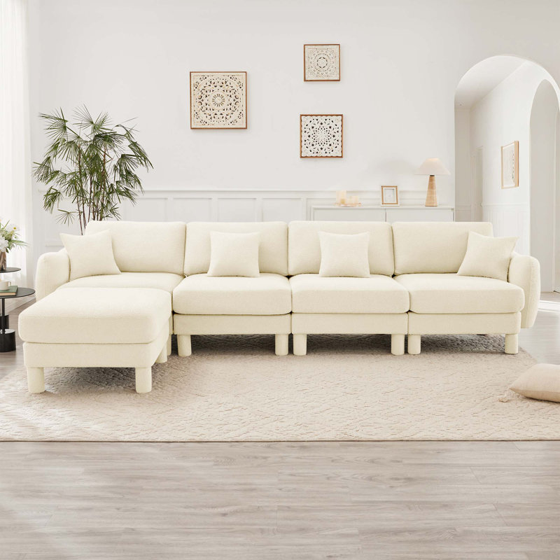 Canapé modulaire en L convertible en L pour 4 personnes avec accoudoirs en forme de coquillage, repose-pieds amovible et pieds cylindriques Boucle
