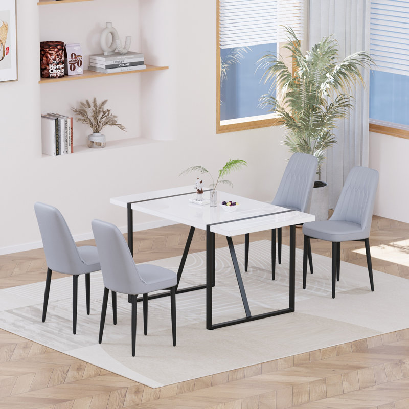 Ensemble de table de salle à manger 55 po en MDF moderne pour 4 personnes, ensemble de table et de chaises avec pieds en métal noir pour cuisine, plateau de table rectangulaire blanc industriel et chaises de salle à manger rembourrées en polyuréthane épais