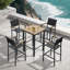 Patio bar set with a faux wood table and four charcoal black stools featuring mesh seats and wood armrests.