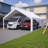 20X20 FT Event Shelter With Detachable Sides And Carport Capability - Equipped With Storage Solutions For Various Outdoor Occasions