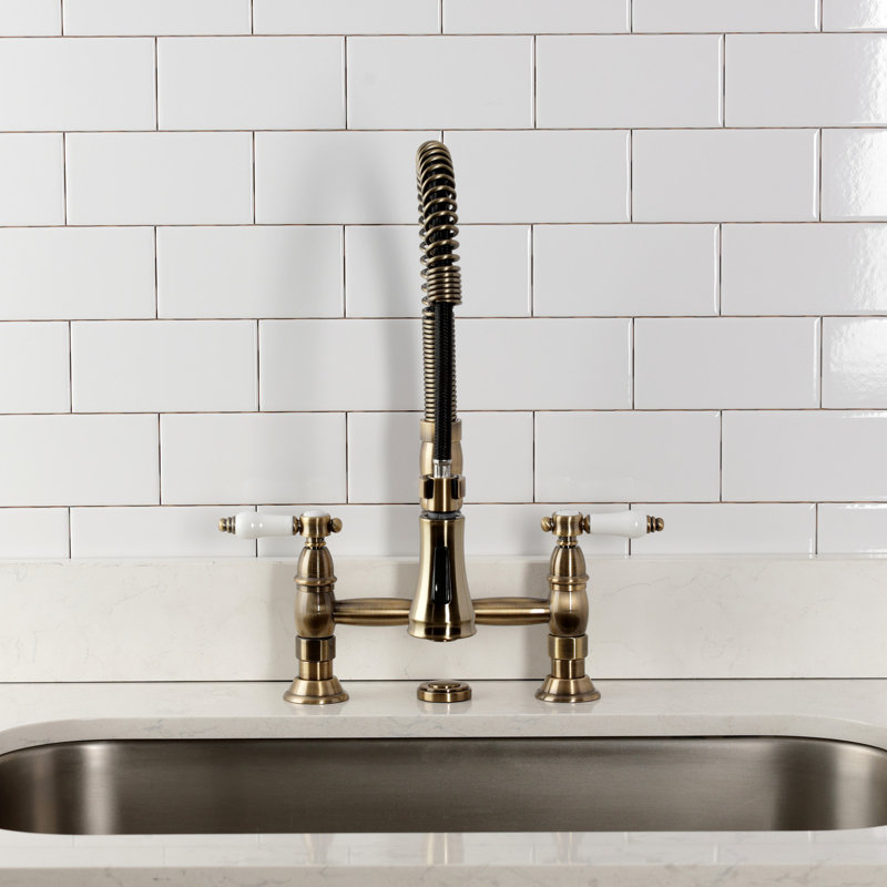 Kingston Brass Bel-Air Double-Handle 2-Hole Deck-Mount Pre-Rinse Bridge Kitchen Faucet, Antique Brass