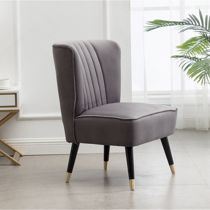 Fauteuil d'appoint contemporain en velours rembourré de mousse dense et au design unique, idéal pour améliorer le confort d'assise et l'esthétique de la pièce