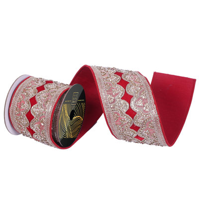 4" x 5yd Velvet Wired Ribbon with Scalloped Champagne Sequin, Jewels, and Pearls. Red Dupion Backing. Measuring 4 inches in width and 5 yards in length, it's perfect for a variety of festive projects.