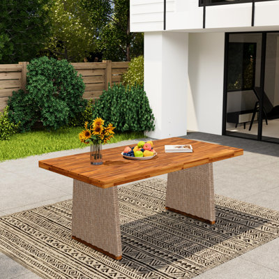 Table de salle à manger d'extérieur en bois avec finition, plateau brun à lattes pour une esthétique soignée.