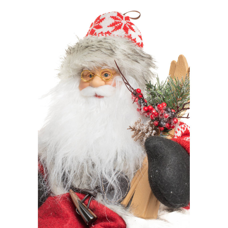 Père Noël alpin assis rouge