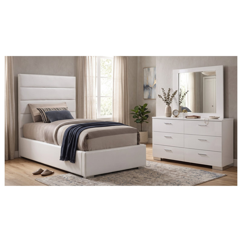 Ensemble de chambre à coucher Genevieve White pour lit simple, comprenant un lit rembourré, une commode et un miroir.