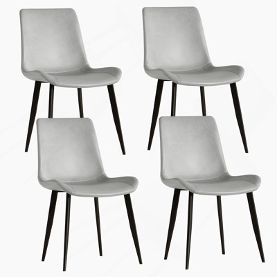 Ensemble de quatre chaises de salle à manger modernes avec un revêtement de haute qualité et des pieds robustes, idéal pour divers espaces intérieurs