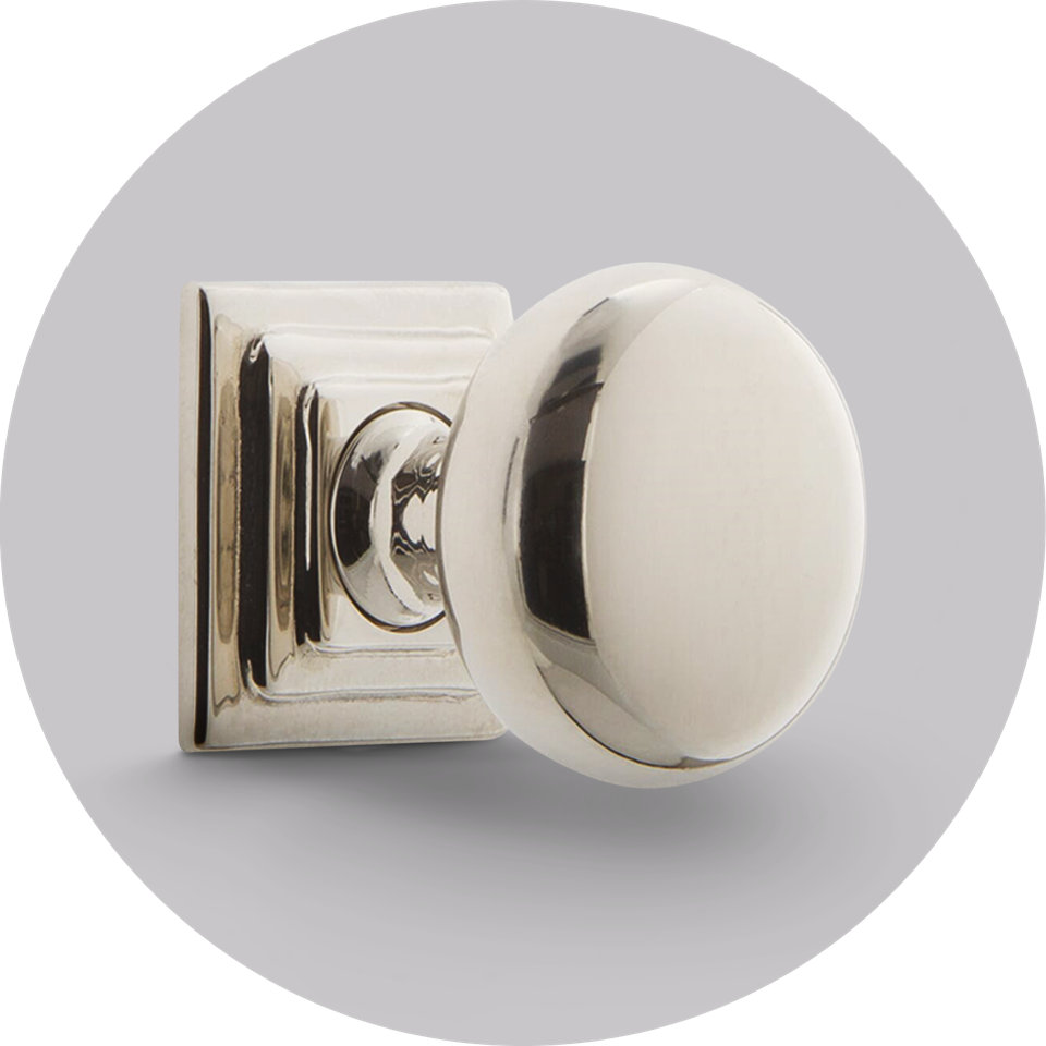 Polished nickel door knob with a round handle and square mounting plate.