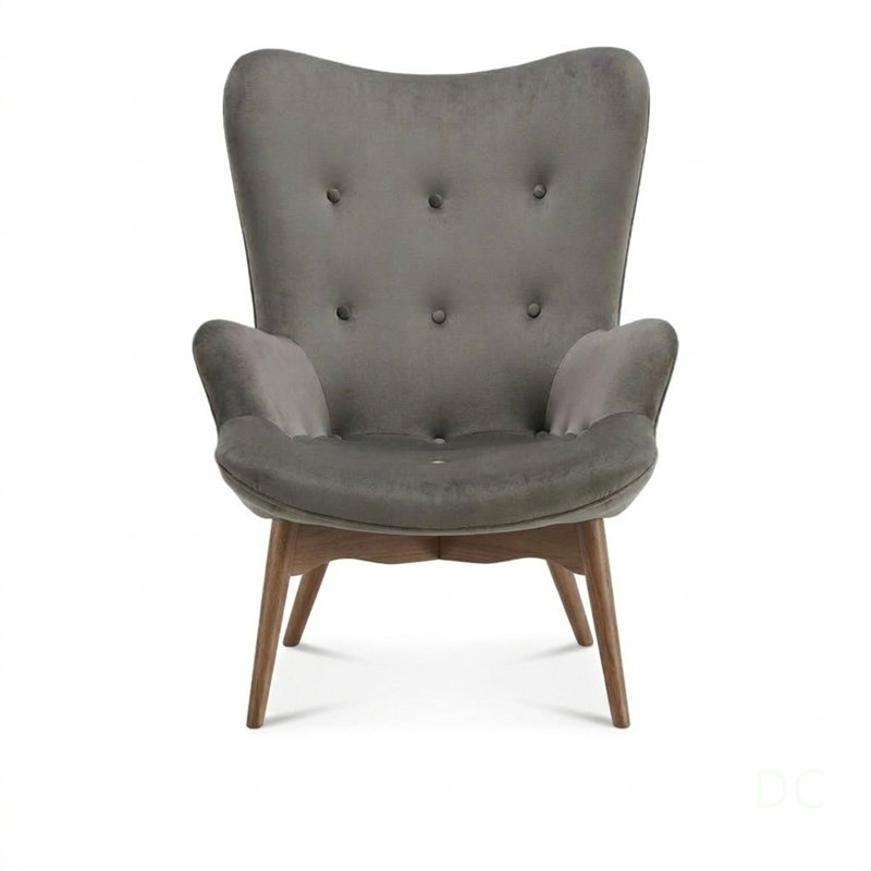 Fauteuil et repose-pieds Contour Lounge avec revêtement en velours et pieds en noyer, parfaits pour une assise moderne et confortable.