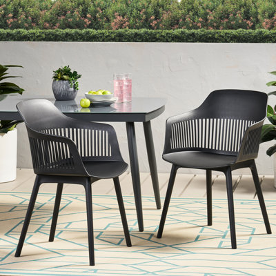 Chaise d'extérieur - Dahlia. Polypropylène noir, résistant aux intempéries. Design élégant et incurvé. 84 cm (H) x 57 cm (L) x 55 cm (P). Stable et robuste. Siège Dahlia : résistant aux intempéries, élégant, 55 cm (P) x 84 cm (H), polypropylène