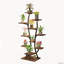 Support pour plantes d'intérieur en forme de vase avec lampes de croissance et tablette métallique.