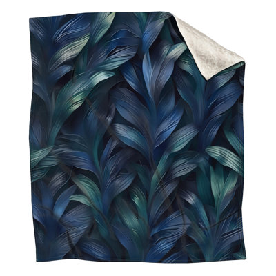 Couvertures bleues, vertes, feuilles tropicales
