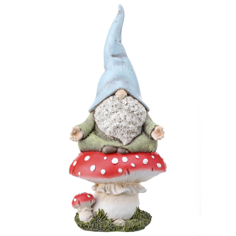 Statue gnome assis sur un champignon