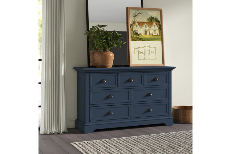 dark blue bedroom dresser with styled decor