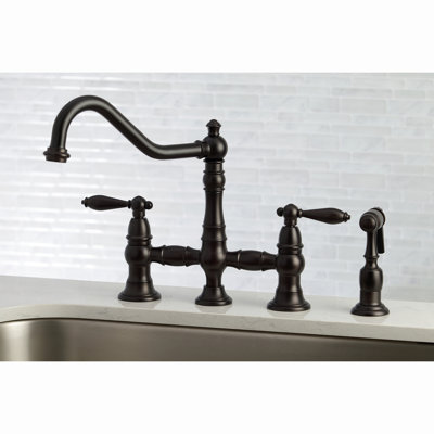 Kingston Brass Restoration Two-Handle 4-Hole Deck Mount Bridge Kitchen Faucet with Brass Side Sprayer