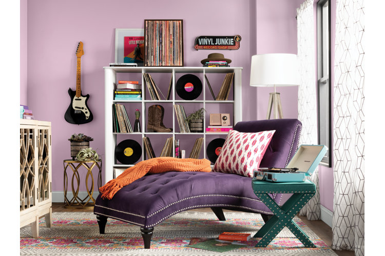 Purple living room with lavender-colored walls and a deep purple chaise lounge.