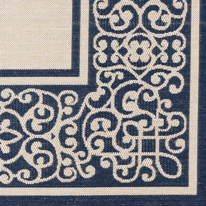 Tapis d'intérieur / extérieur en polypropylène tissé à plat à bordure à volutes crème bleu marine beige Solterra Guilhermino
