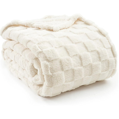 Jeté en polaire à carreaux doux et confortable pour lit et canapé.
