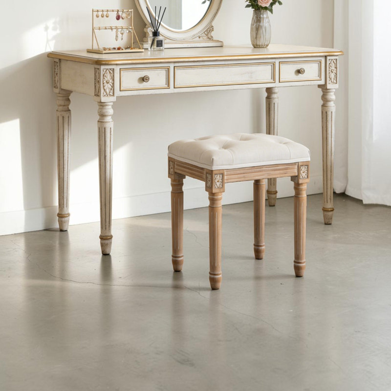 Tabouret de coiffeuse Fornear en lin, pieds en bois massif sculpté, banc de toilette au design capitonné, Beige
