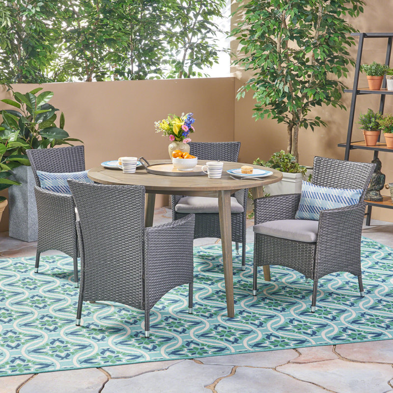 Cambriah 4 - Person Acacia Wicker Patio Dining Set with Round Table , Cushions Included, Gray Frame / Silver Cushion