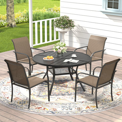 Ensemble repas pour 4 personnes avec table de salle à manger ronde et 4 chaises empilables en textilène