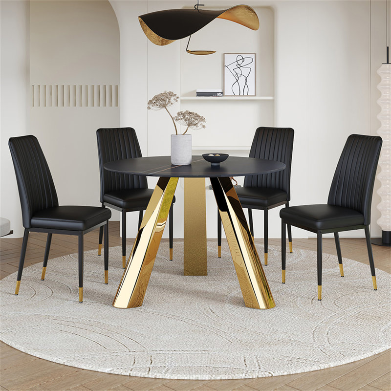 Une table de salle à manger ronde de 42 pouces avec un plateau en granit et des pieds en acier inoxydable