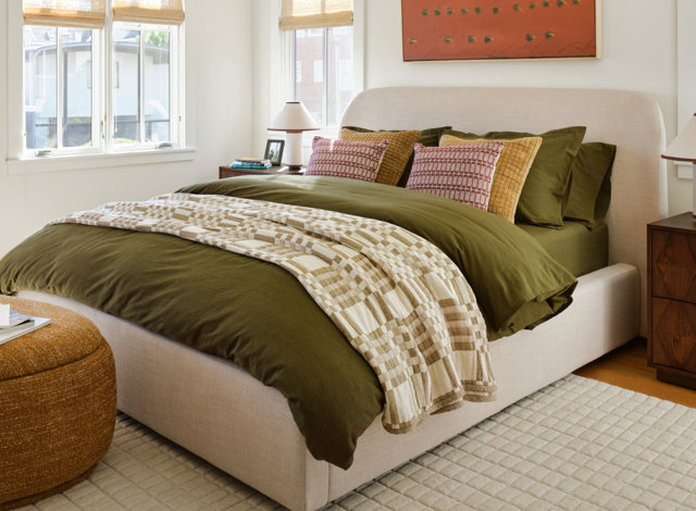 Living room with green couch and yellow pillows for pro pricing section