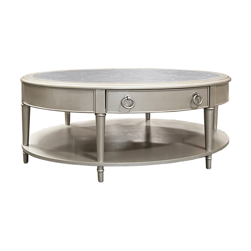 Table basse, pierre frittée et finition champagne