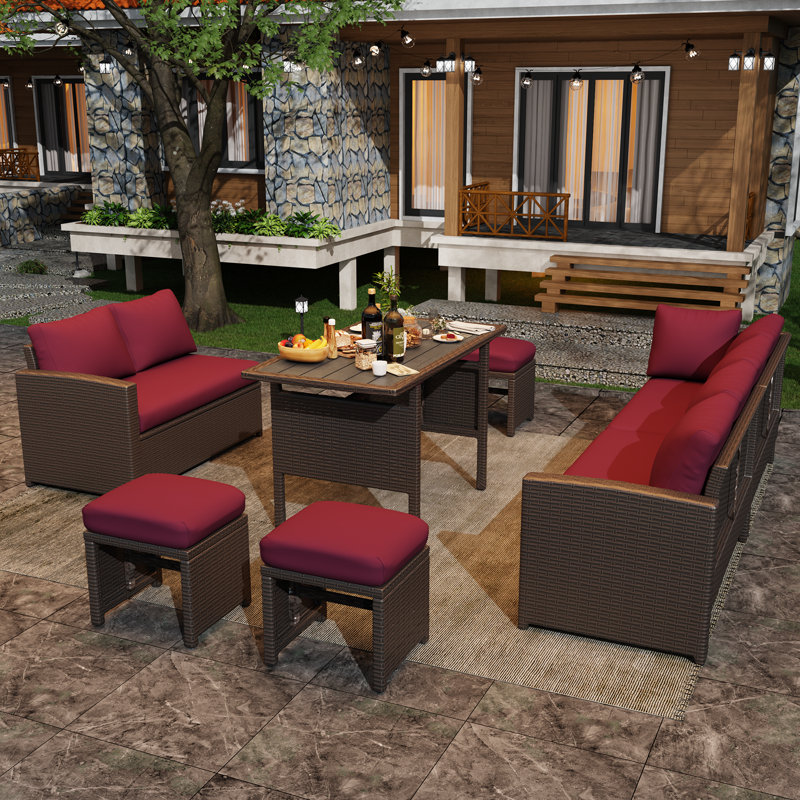 Chaise longue en rotin 7 pièces avec coussins Hinesville, Structure brune / coussin rouge vin