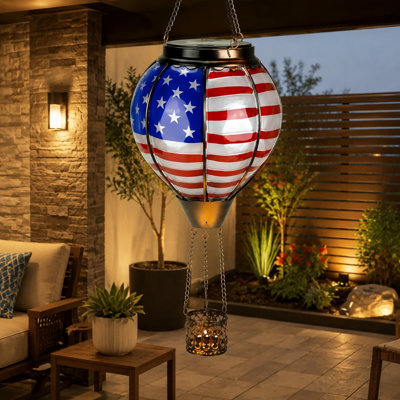 This Hot Air Balloon solar lantern uses durable American Flag Glass with a Flickering Flame Effect; the Rustproof, Waterproof hanging light provides garden decor for patios, yards, or porches and can be given as a gift.