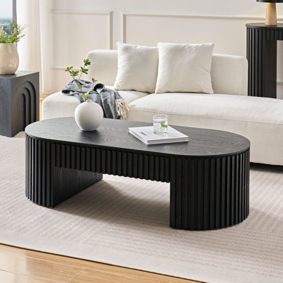 " oval mid-century modern coffee table in black, wood construction with storage drawer for living room