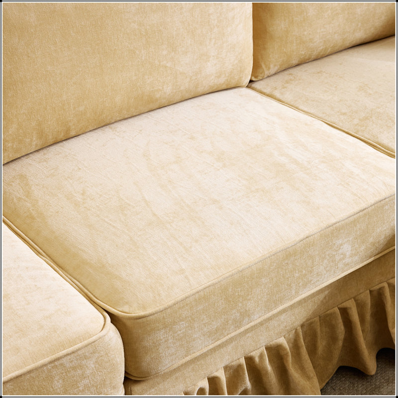 Canapé d'angle moderne en chenille d'une forme en L avec jupe à volants amovible et pouf pour un confort optimal dans votre salon