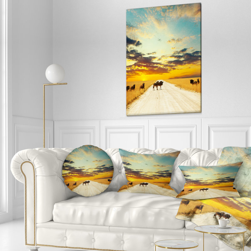 Wildebeests Crossing Path in Evening - Landscape Printed Throw Pillow