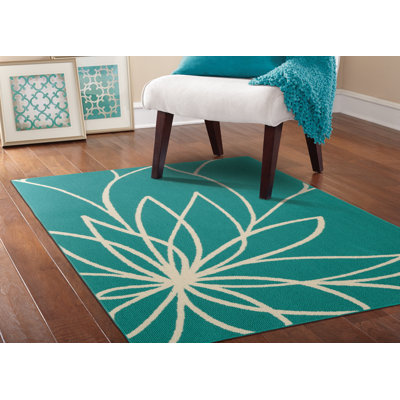 Tapis sarcelle / ivoire touffeté à motif floral Tihiri